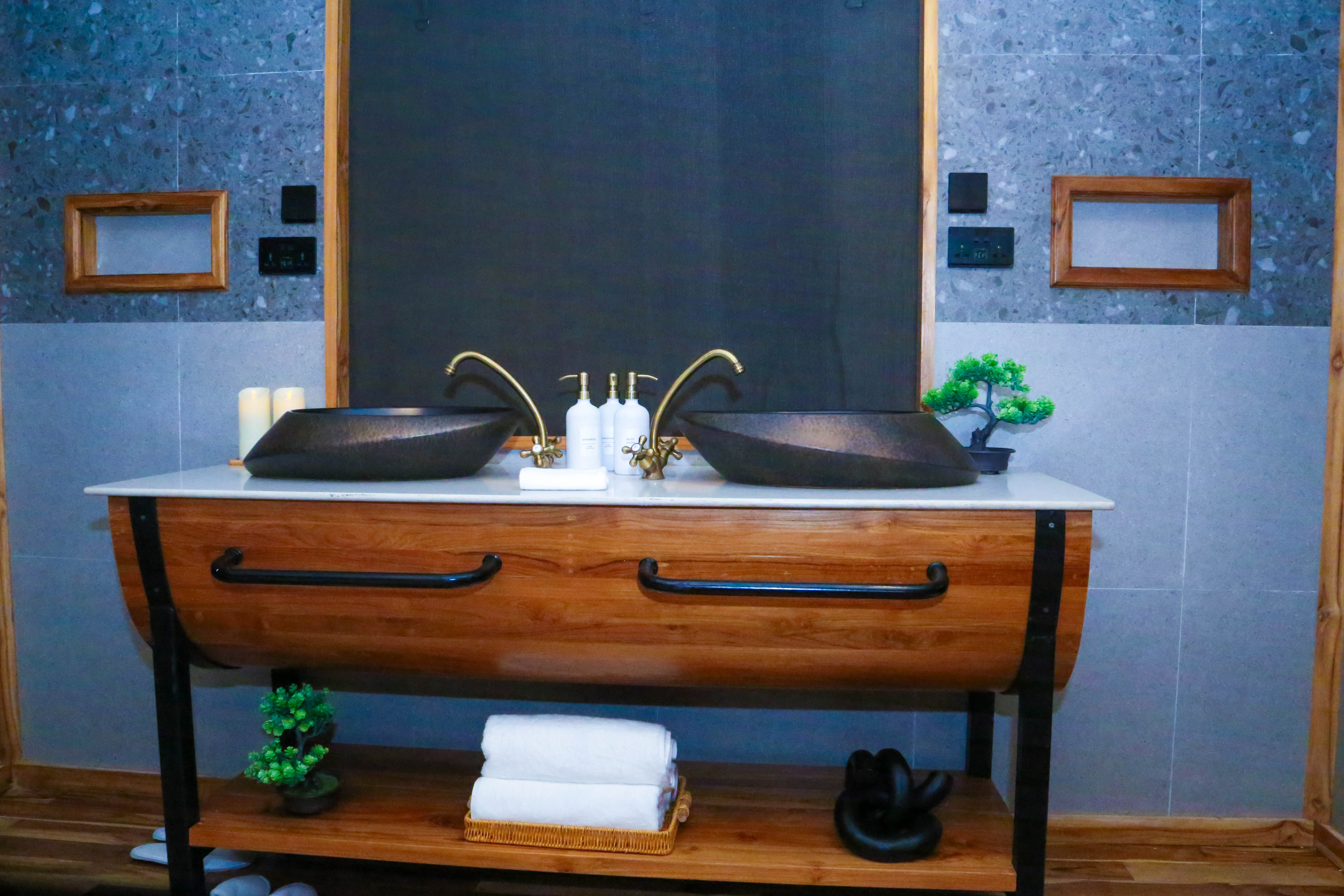 Elegant bathroom with dual black vessel sinks and blue tile accent wall