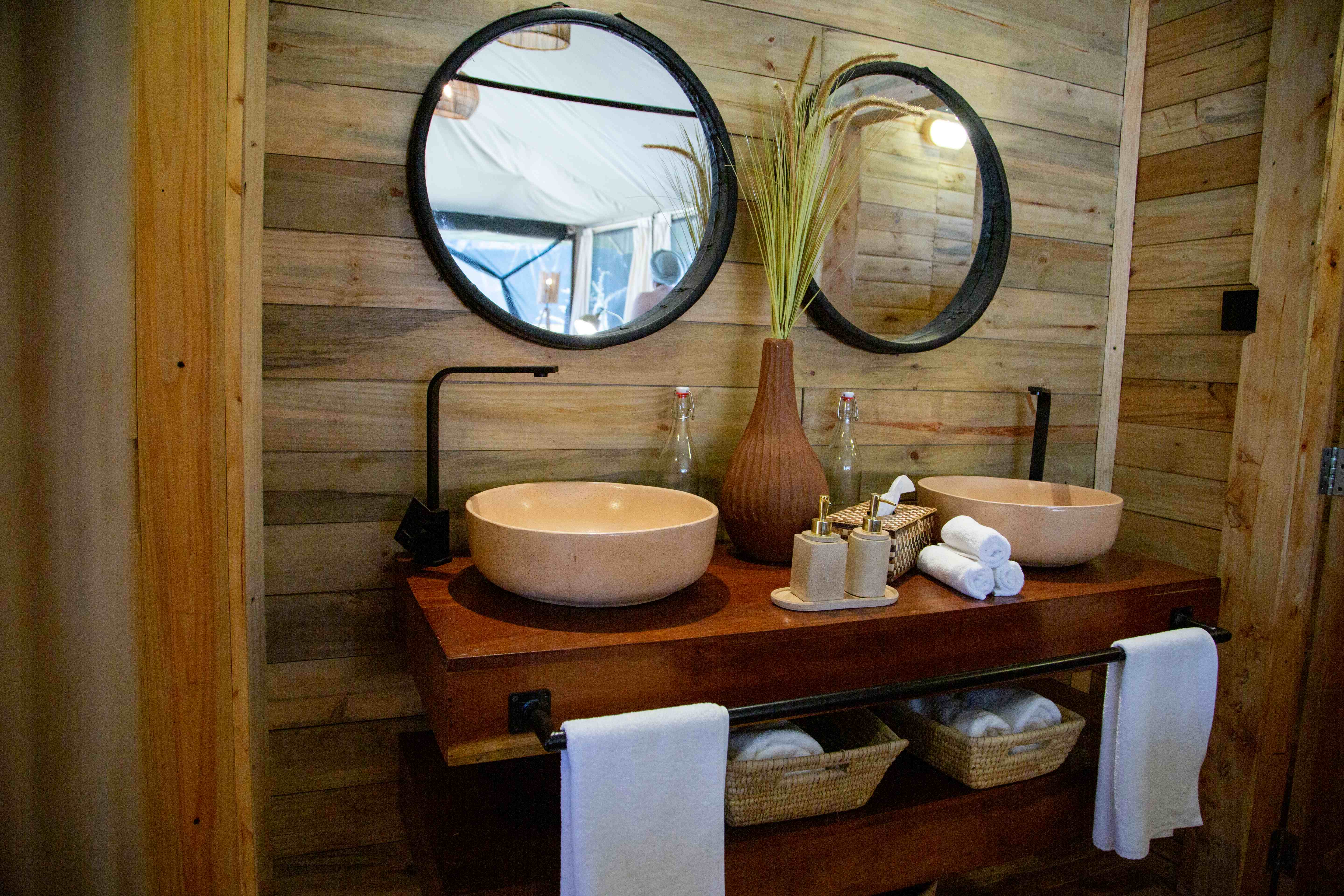 Luxury bathroom with dual vessel sinks and rustic wooden wall paneling