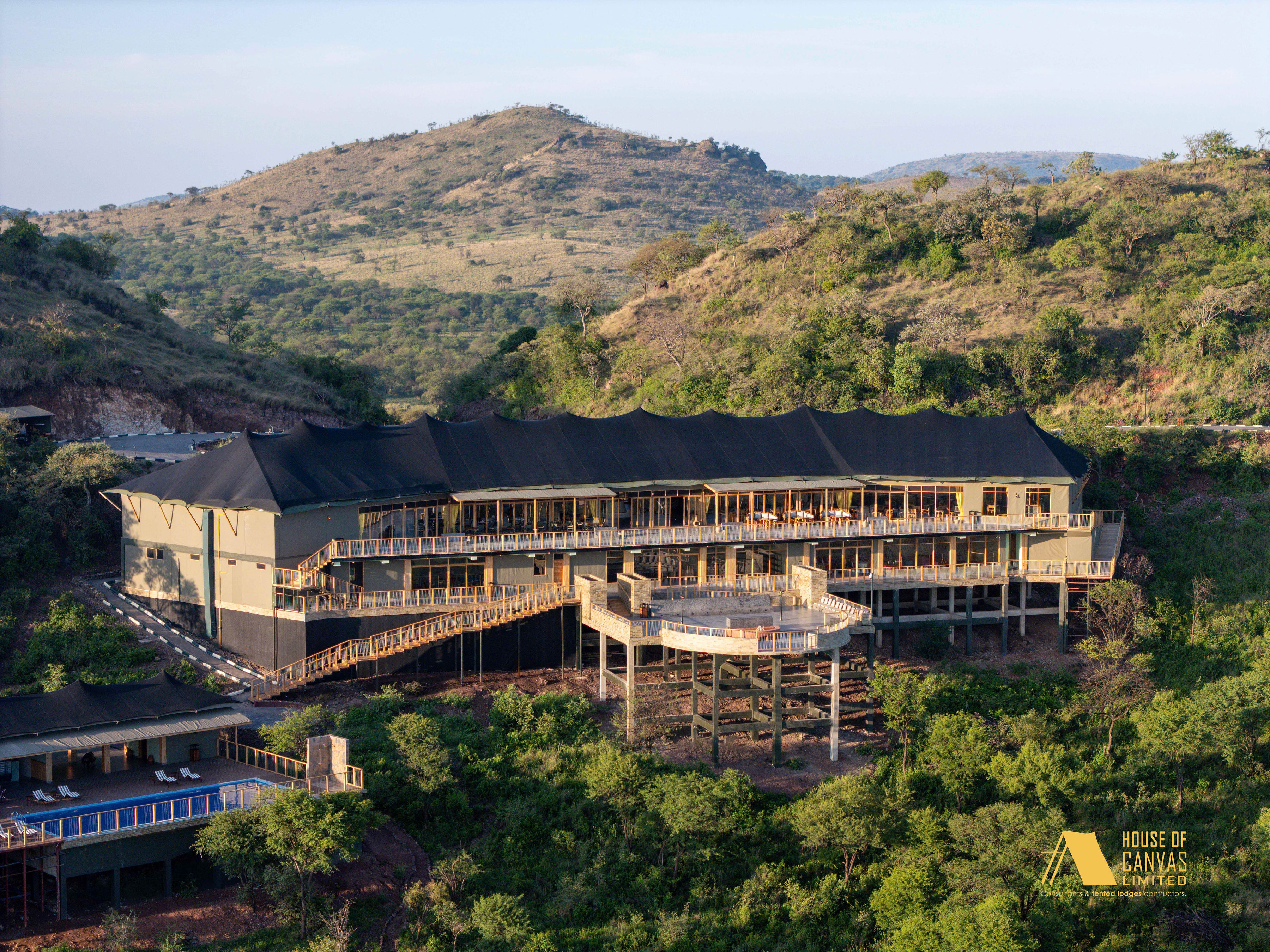 Aerial perspective of luxury camp with surrounding wilderness