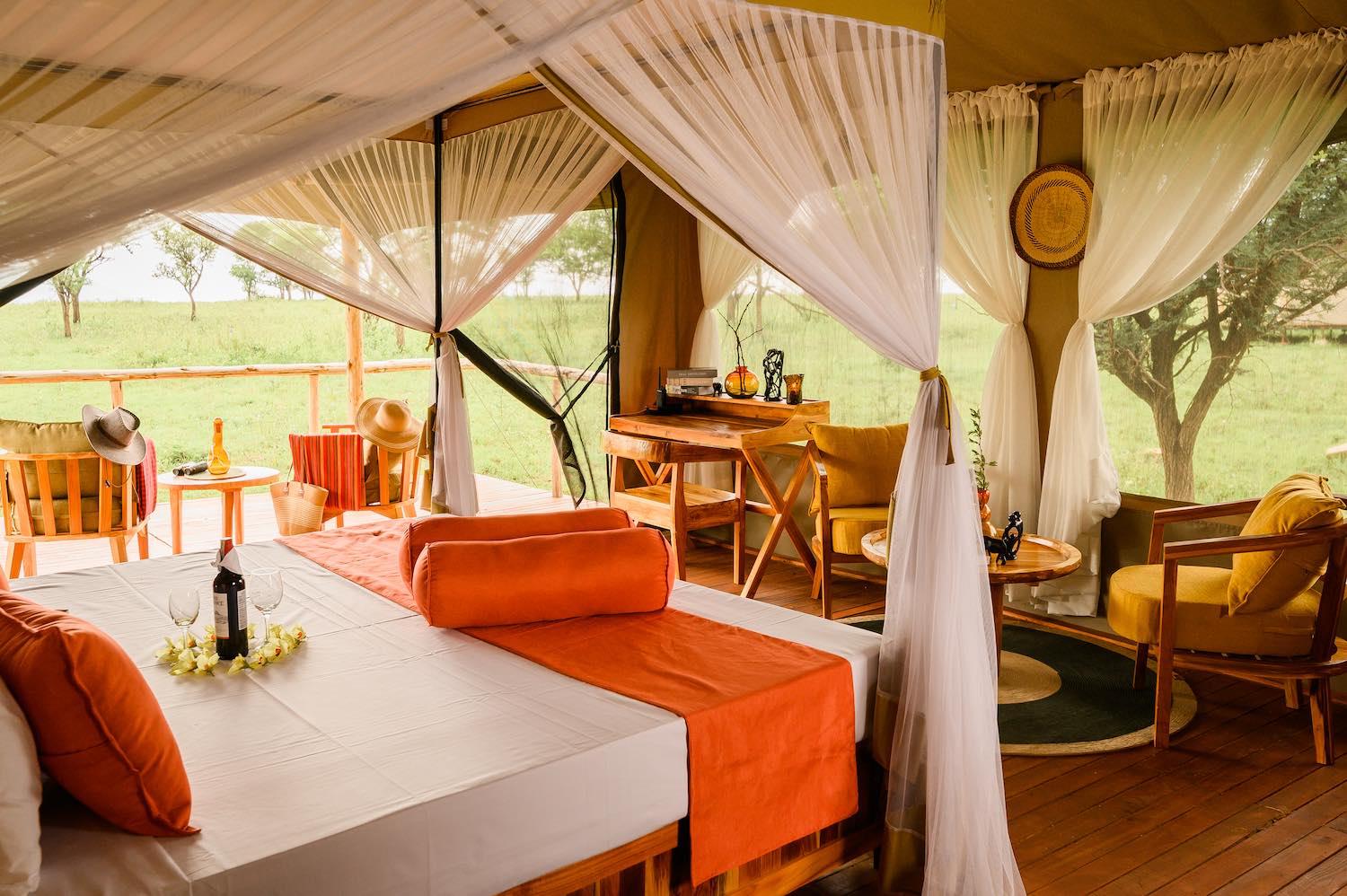 Romantic tent interior with savanna views and intimate seating