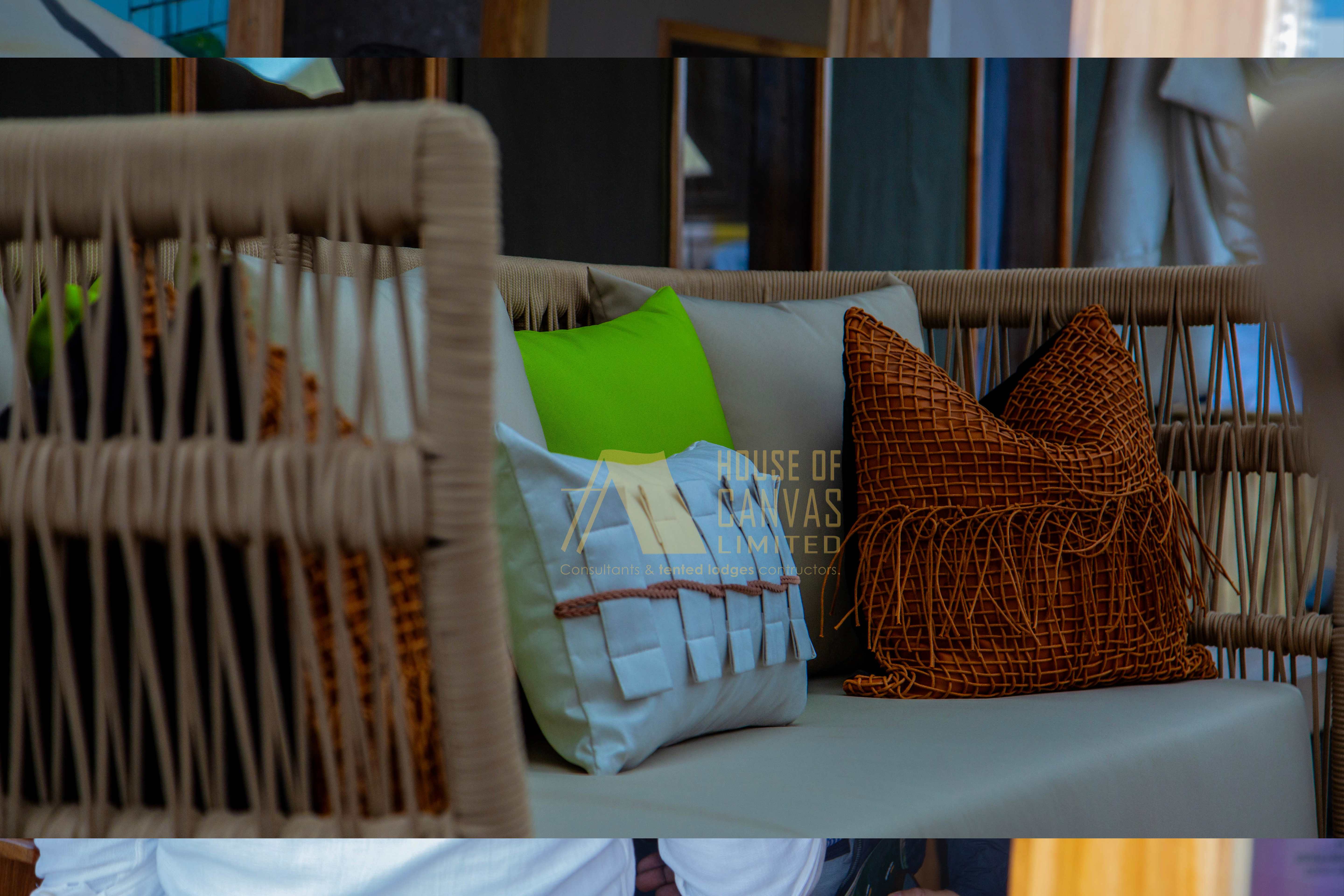 Close-up of woven furniture with colorful pillows showcasing interior styling