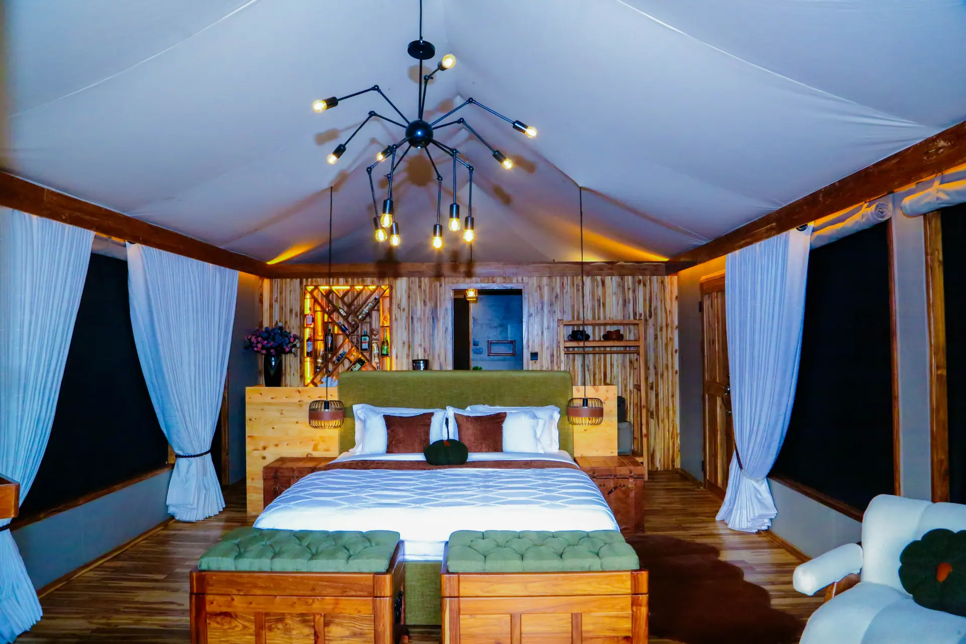 Luxurious bedroom with wooden wine rack feature wall and dramatic lighting