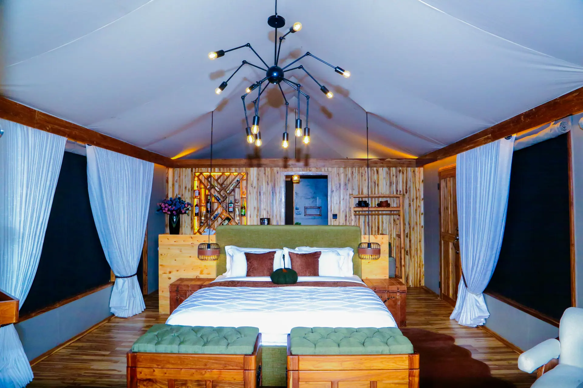 Luxurious bedroom with wooden wine rack feature wall and dramatic lighting