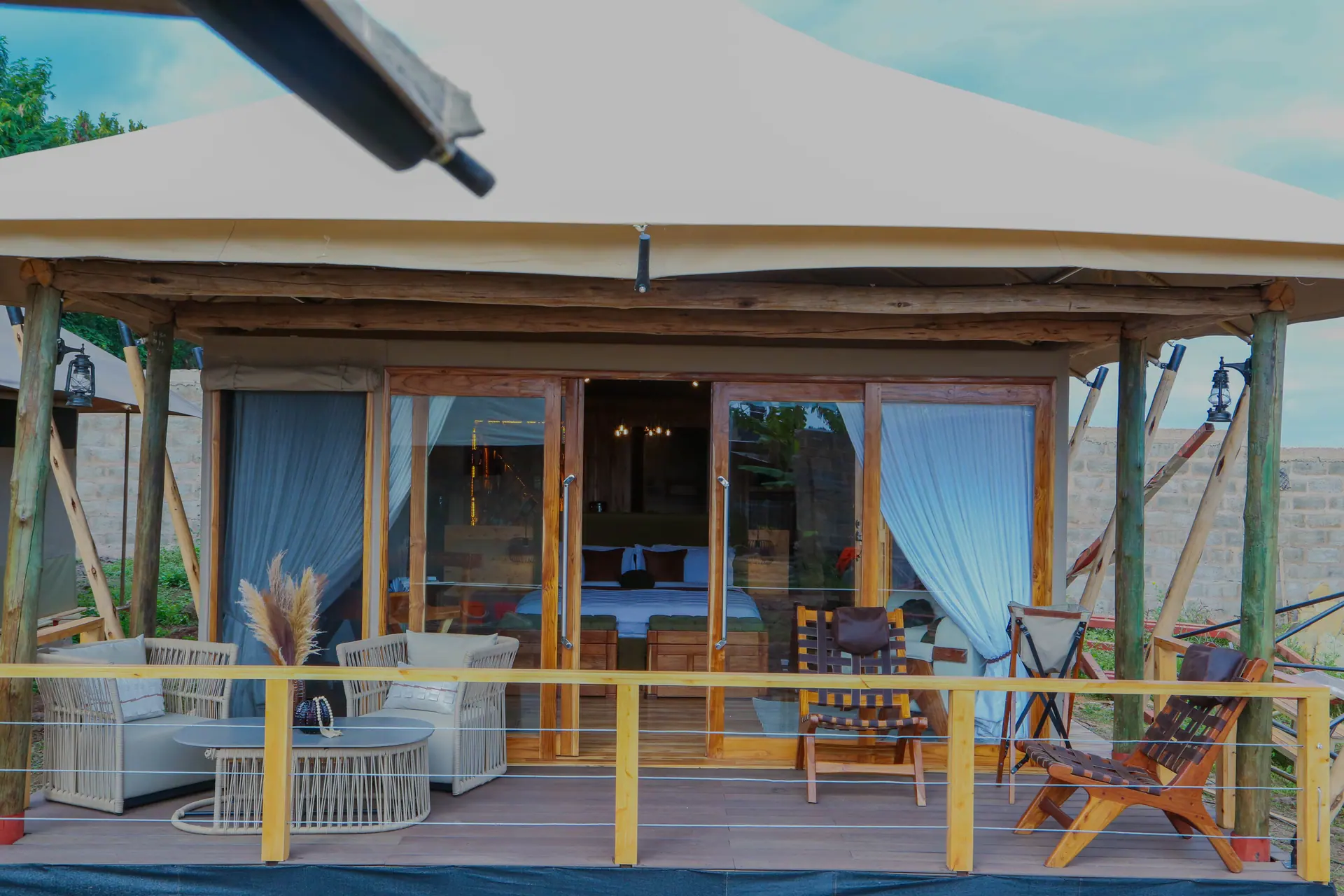 House of Canvas outdoor deck with wooden structure and curtains