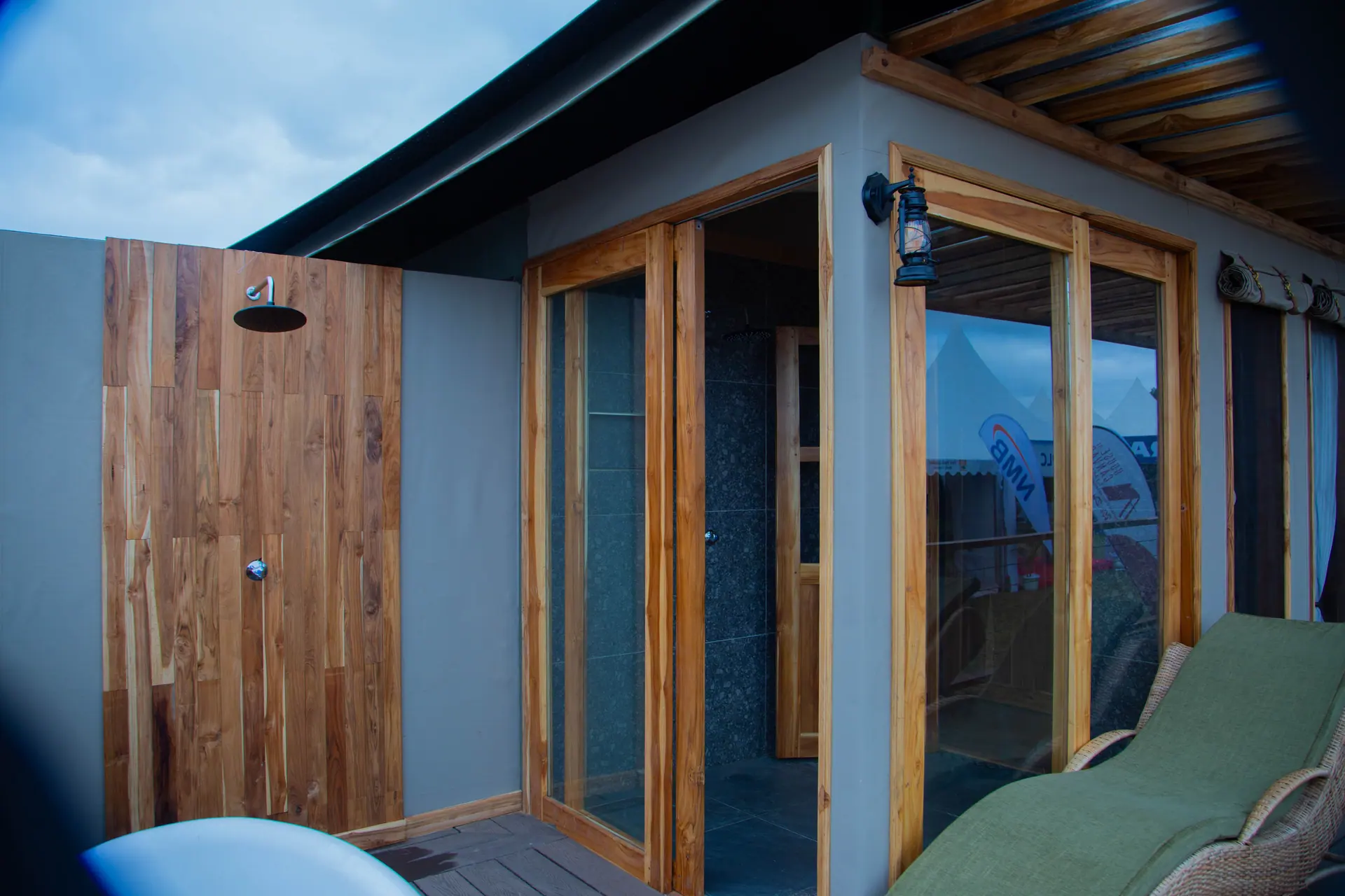 Tent deck with wooden door and outdoor shower