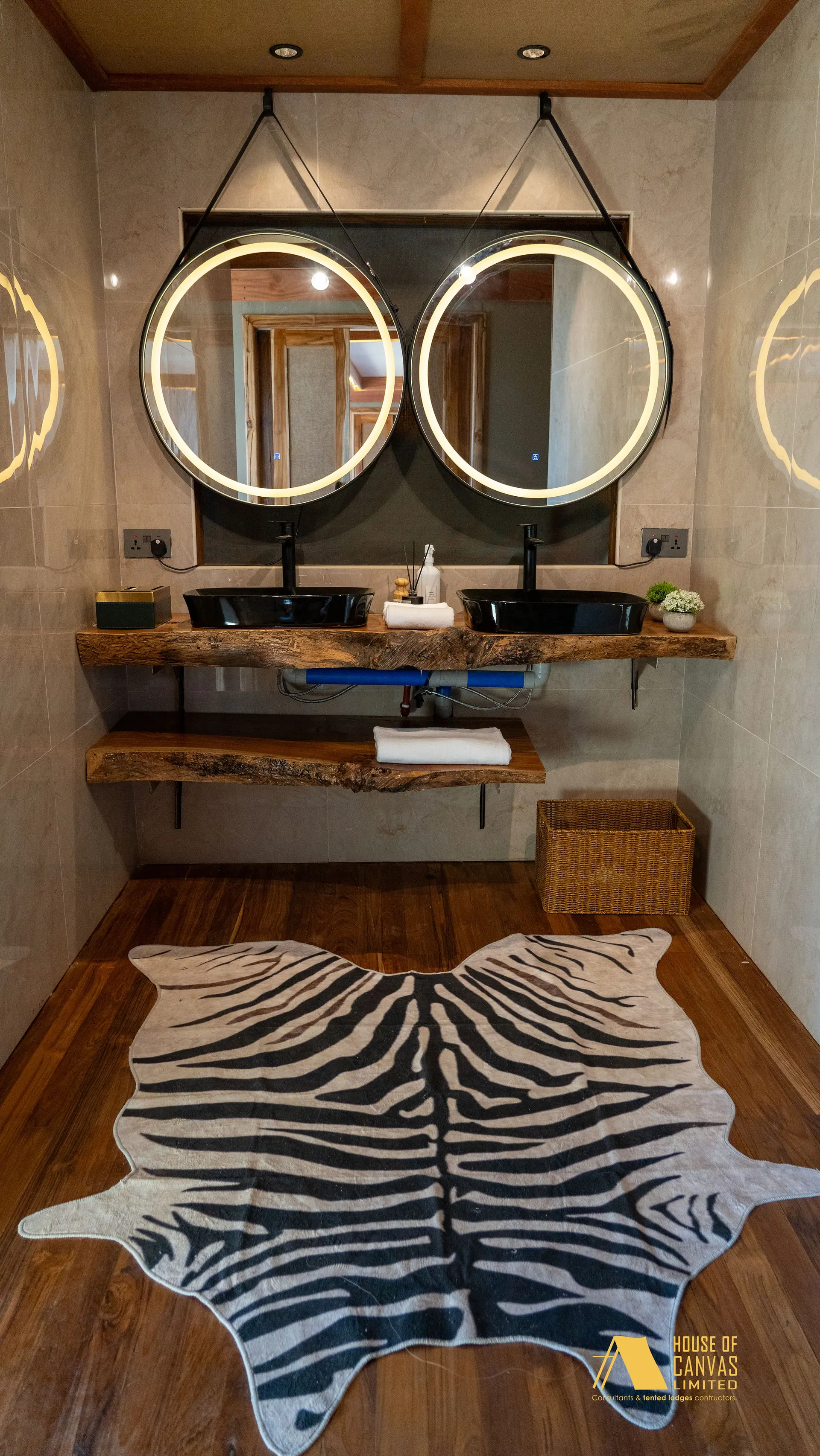 Kili Fair 2026 bathroom with zebra hide rug and twin stone basins